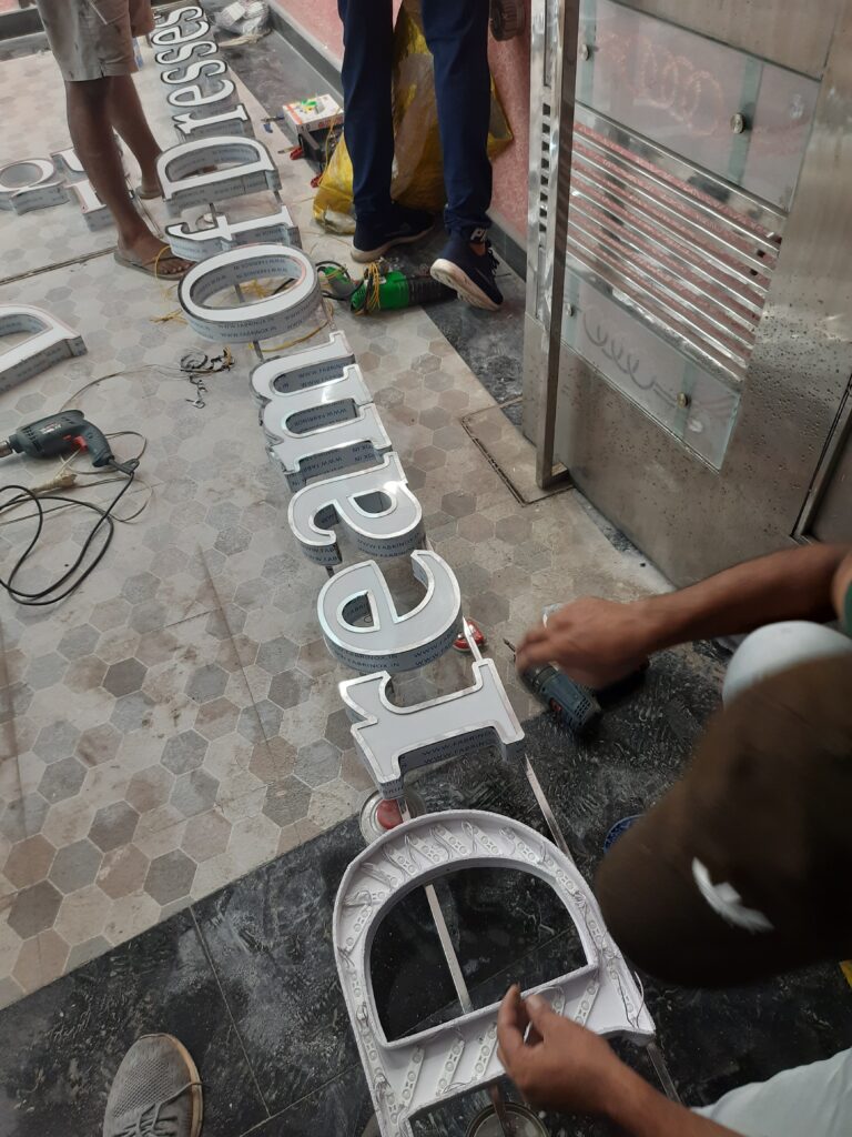 Installation of SS Letters on SS Frame in Progress.