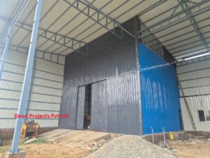 Grey and blue sheet covered storage warehouse with tall walls and transparent roof sheet for natural light