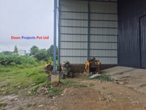 30 ft high warehouse structure with 6×6 inch square pillars fixed to an RCC foundation using anchor bolts